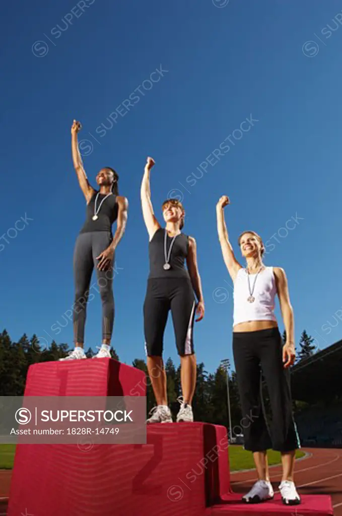 Champion Athletes Standing on Podium   