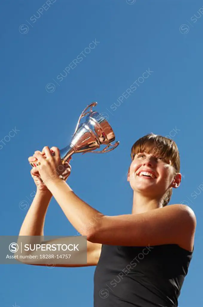 Champion Athlete Holding Trophy   