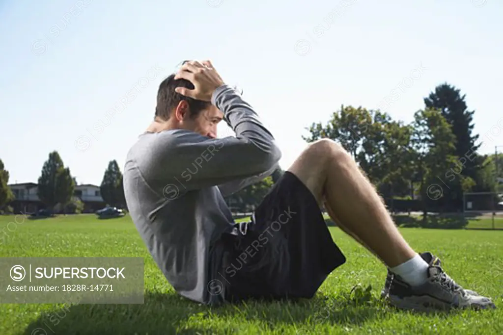 Man Doing Sit-ups Outdoors   