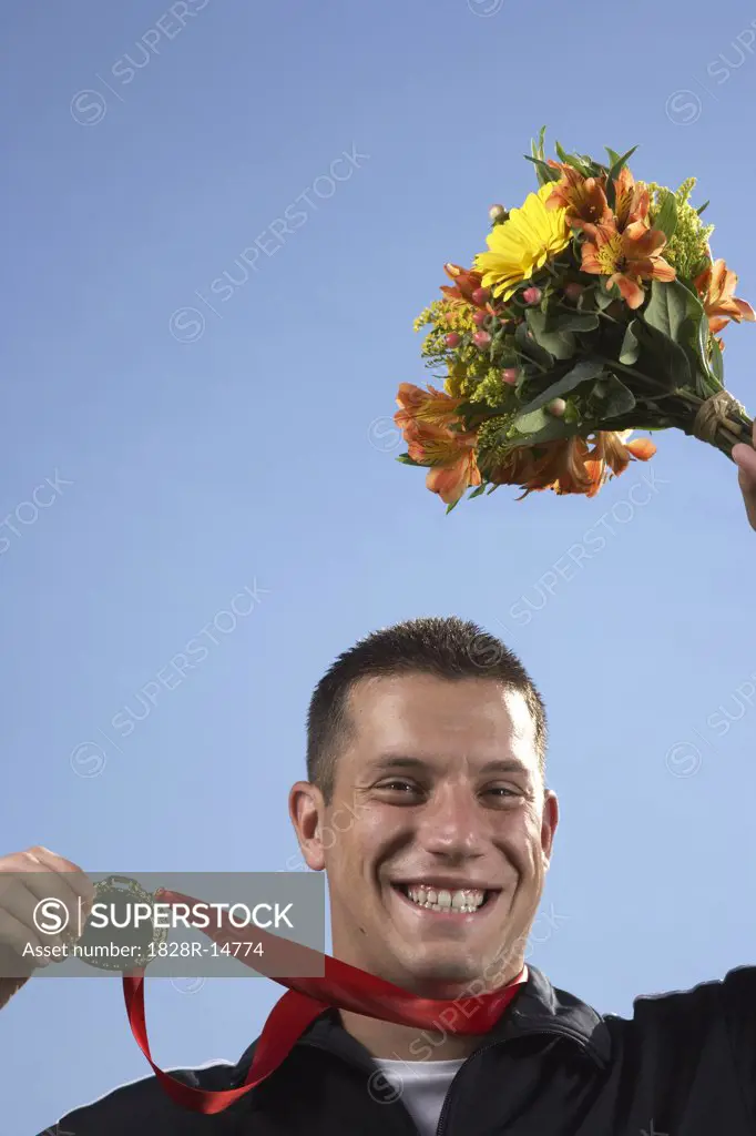 Man Holding Medal and Bouquet   