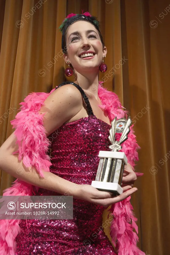 Woman on Stage Holding Trophy   