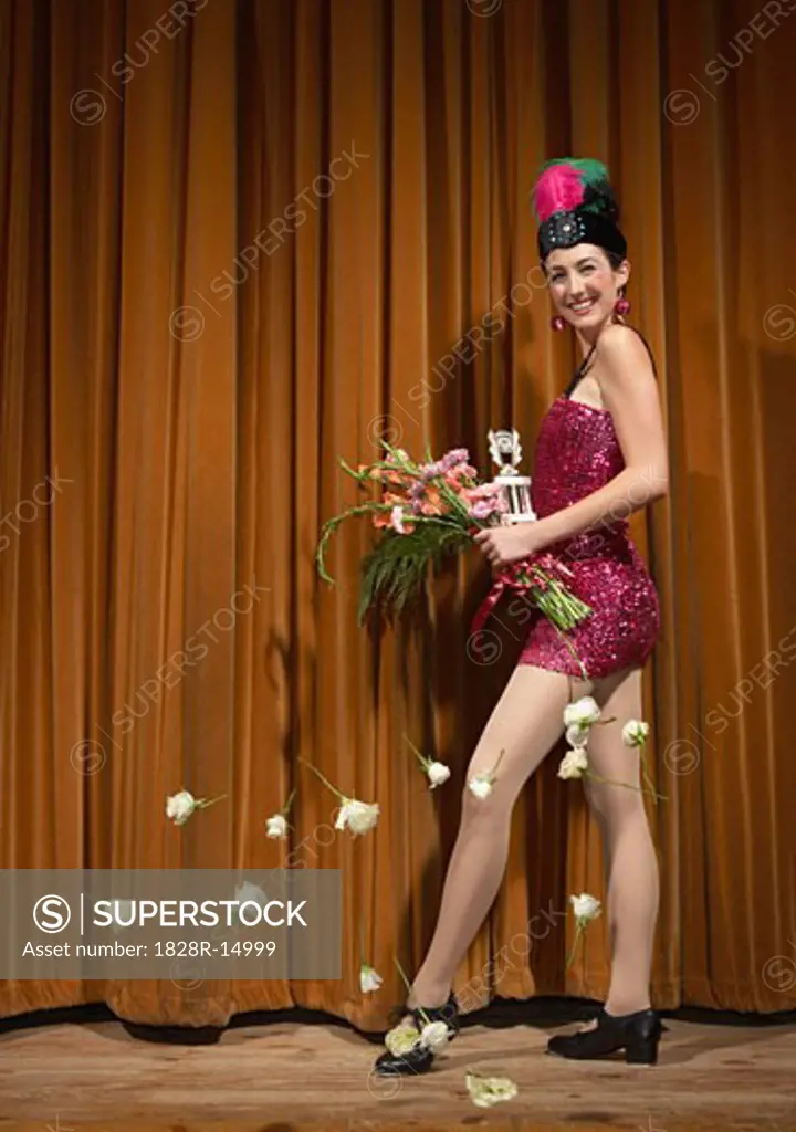 Woman on Stage Holding Flowers   