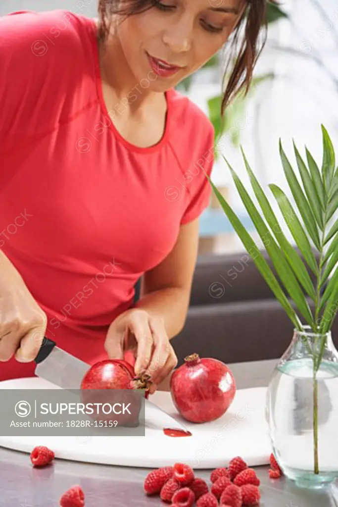 Woman Cutting Pomegranate   