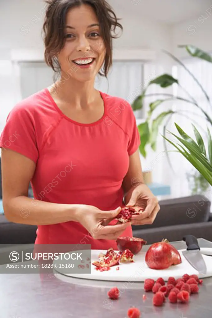 Woman Preparing Pomegranate   