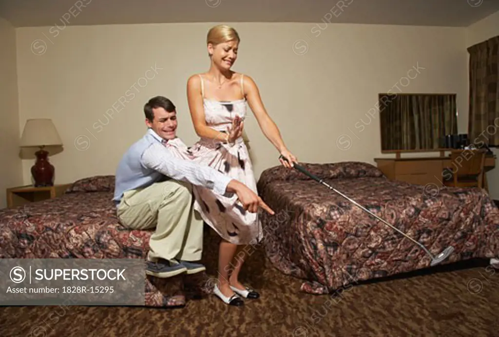 Couple in Motel Room, Man Making Woman Kill Bug   