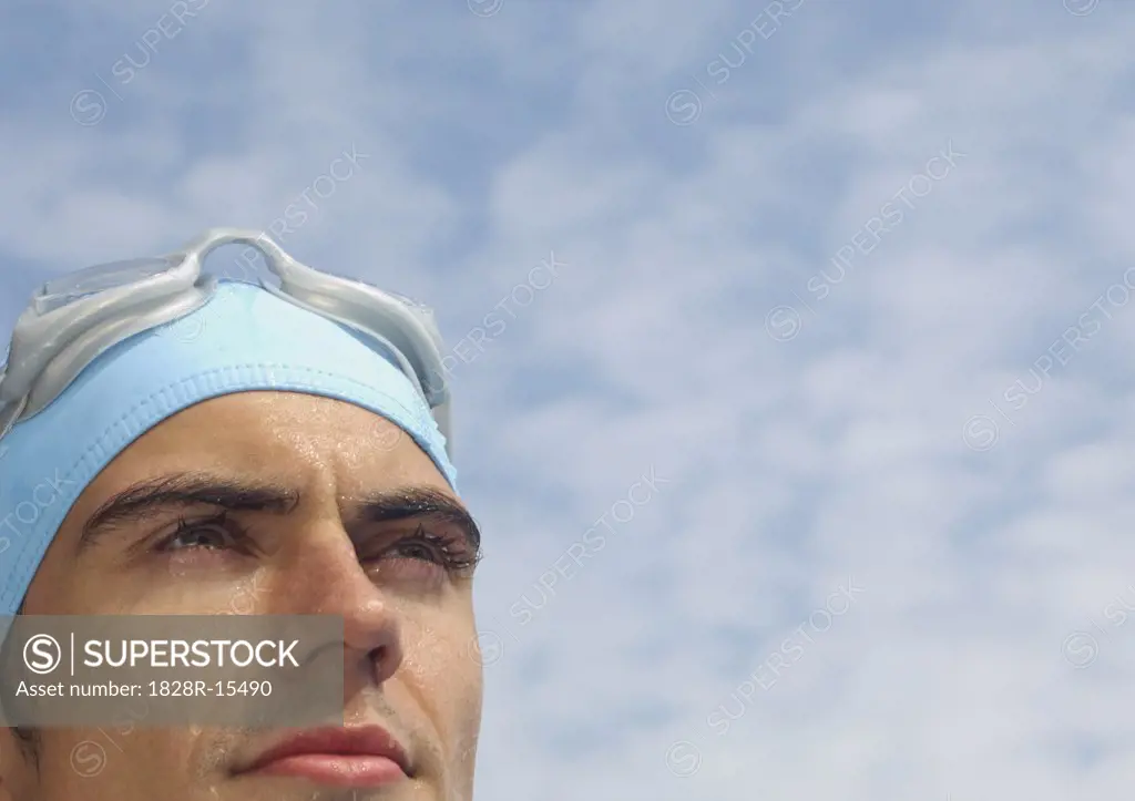 Man Wearing Bathing Cap and Swim Goggles   