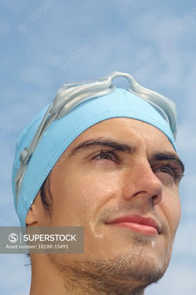Man Wearing Bathing Cap and Swim Goggles   