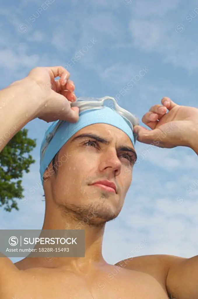 Man Wearing Bathing Cap and Swim Goggles   