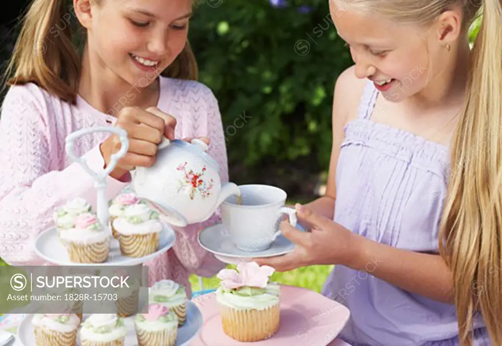 Girl Pouring Tea at Tea Party   