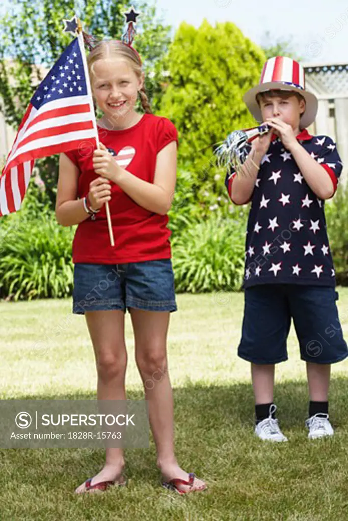 Portrait of Girl Holding American Flag with Boy Wearing Stars and Stripes Top and Hat   