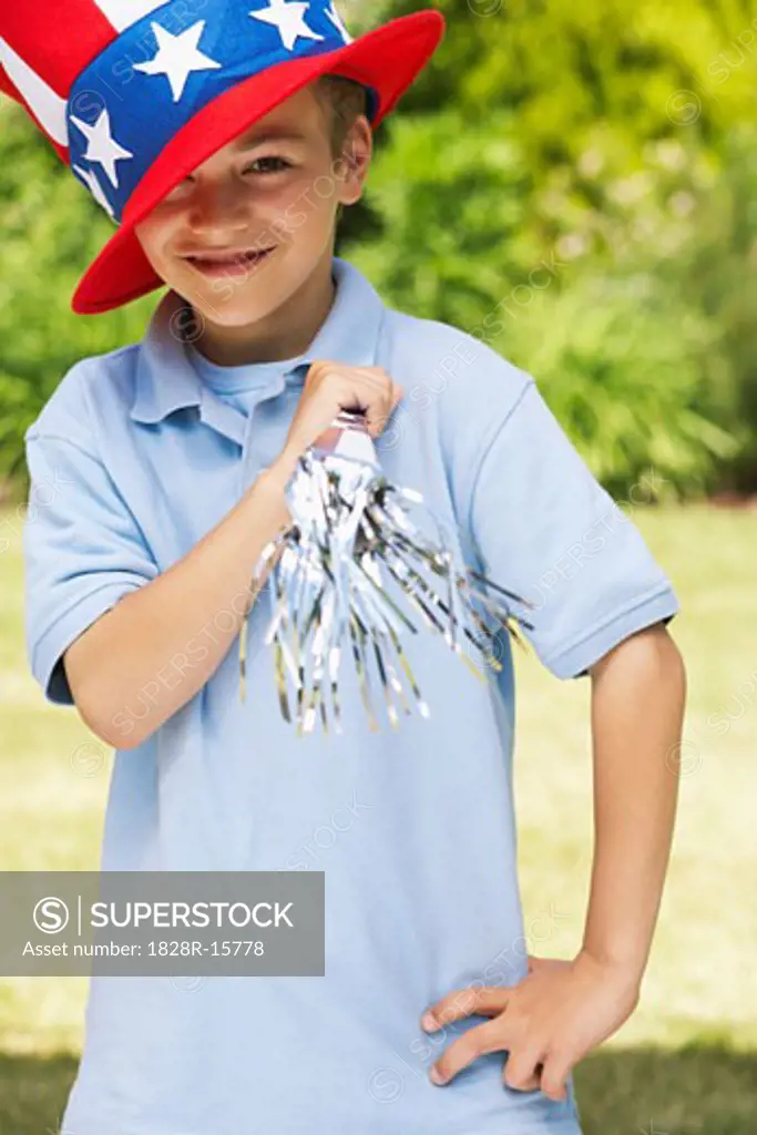 Portrait of Boy Wearing Large Stars and Stripes Hat, Holding Noisemaker Horn   