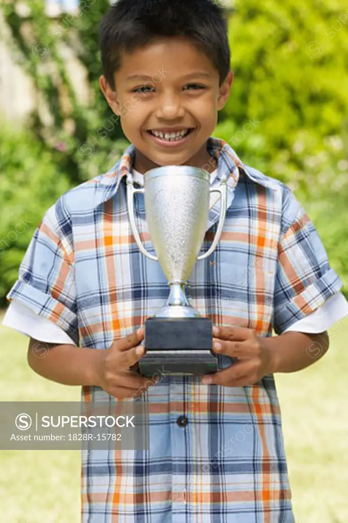 Portrait of Boy Holding Trophy   