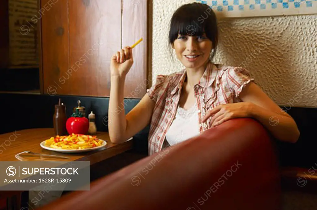 Woman Eating French Fries   