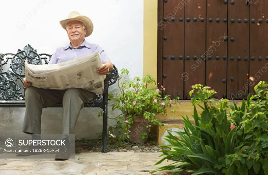 Man Reading Newspaper Outdoors   