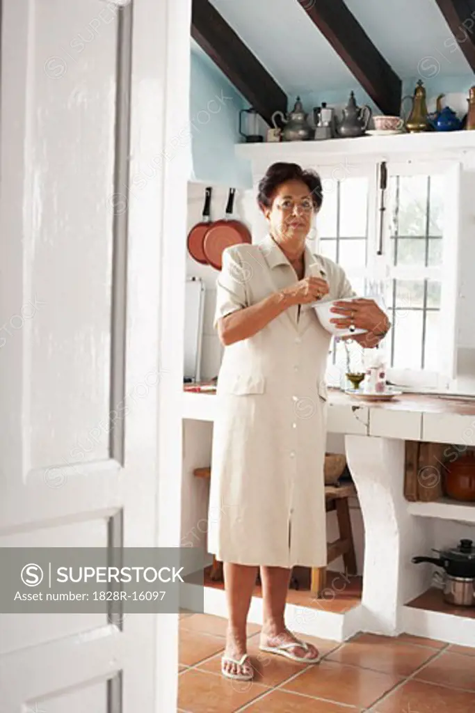 Woman with Mixing Bowl in Kitchen   