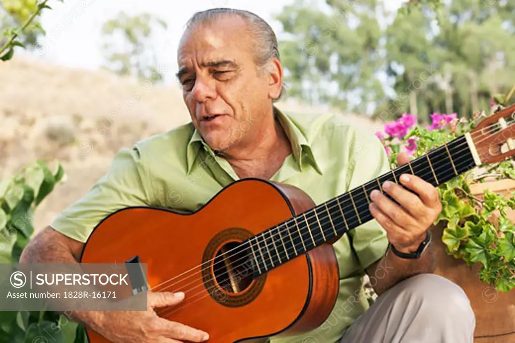 Portrait of Man Playing Guitar   