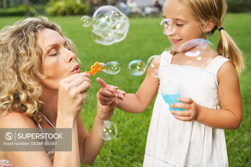 Mother and Daughter Blowing Bubbles   