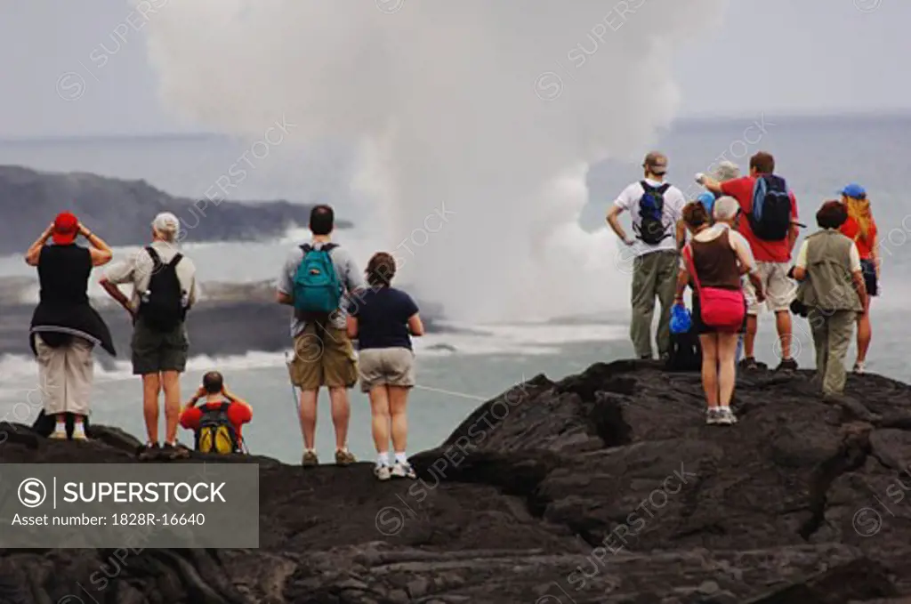 Tourists Standing on Lava, Looking at the Ocean, Hawaii, USA   