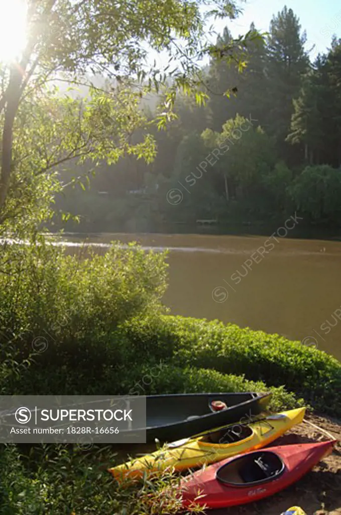 Canoes on Riverbank   