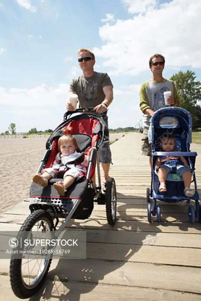 Fathers with Babies in Strollers Walking Along Boardwalk   