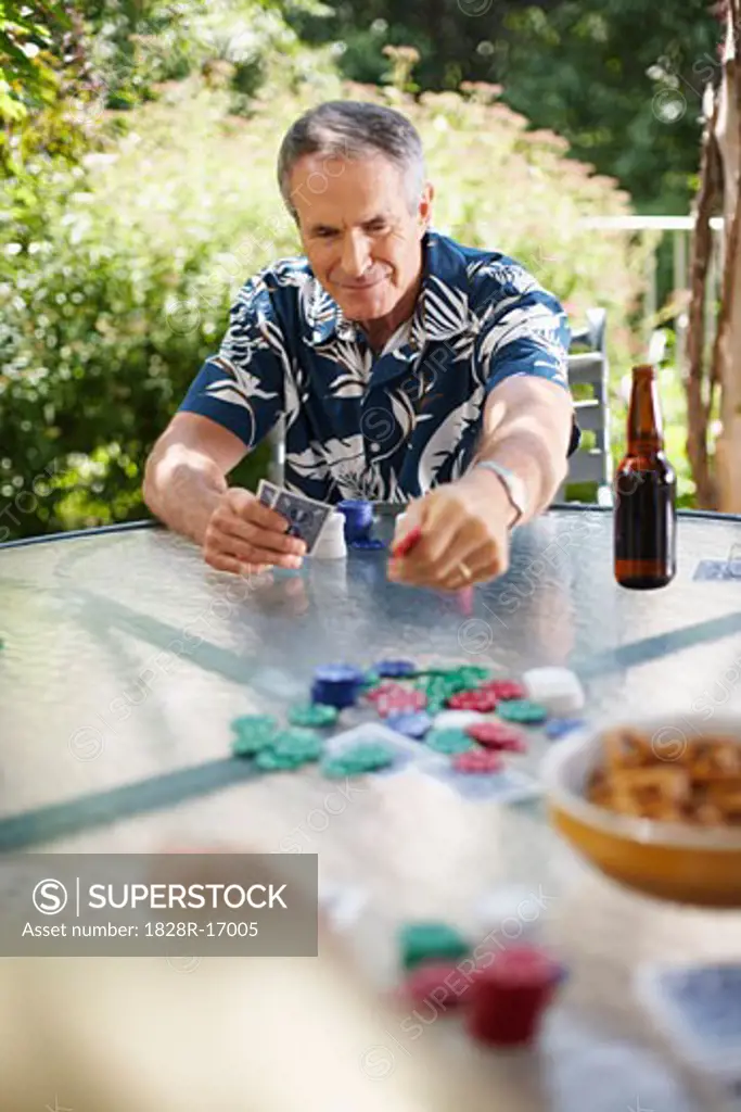 Man Playing Cards Outdoors   
