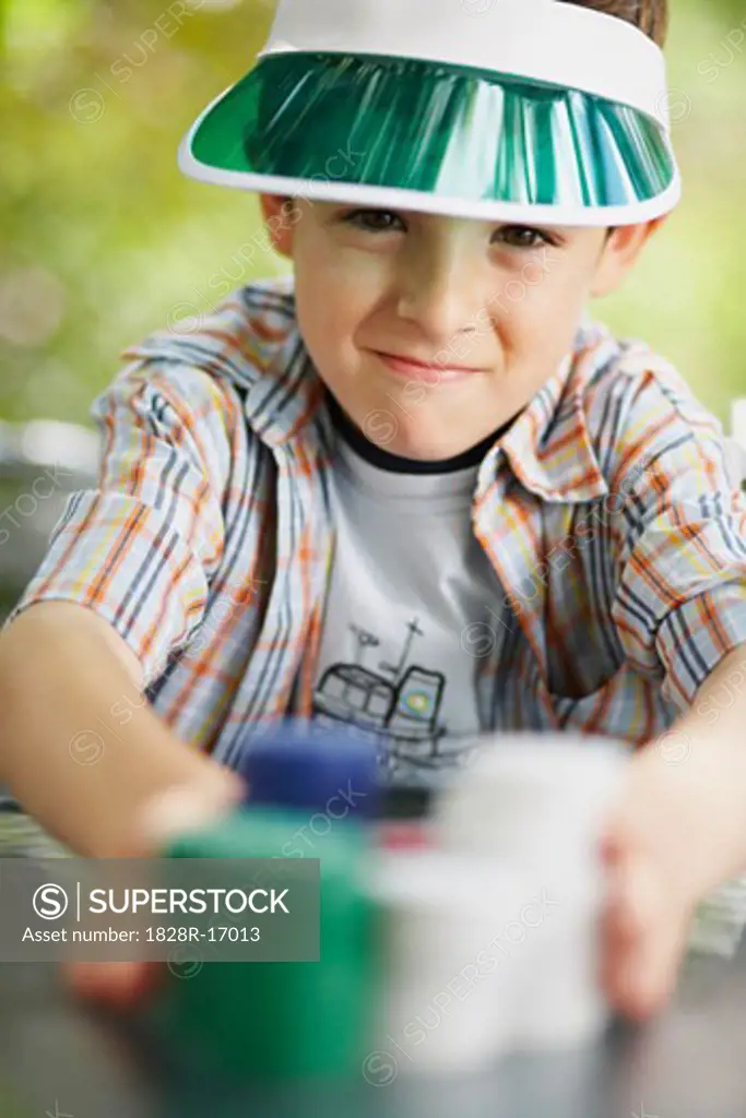 Boy with Stacks of Poker Chips   