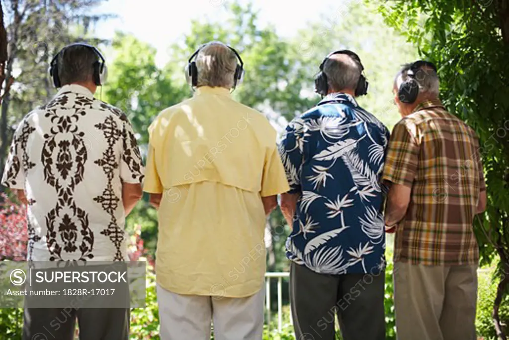 Men Wearing Headphones Listening to Music   