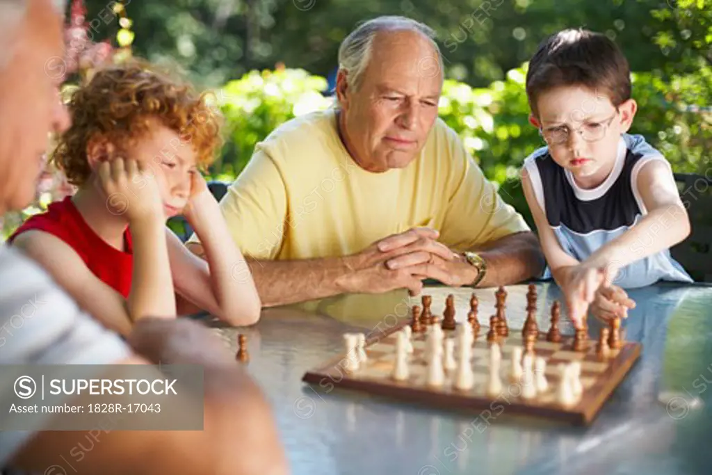 Men Playing Chess with their Grandsons   