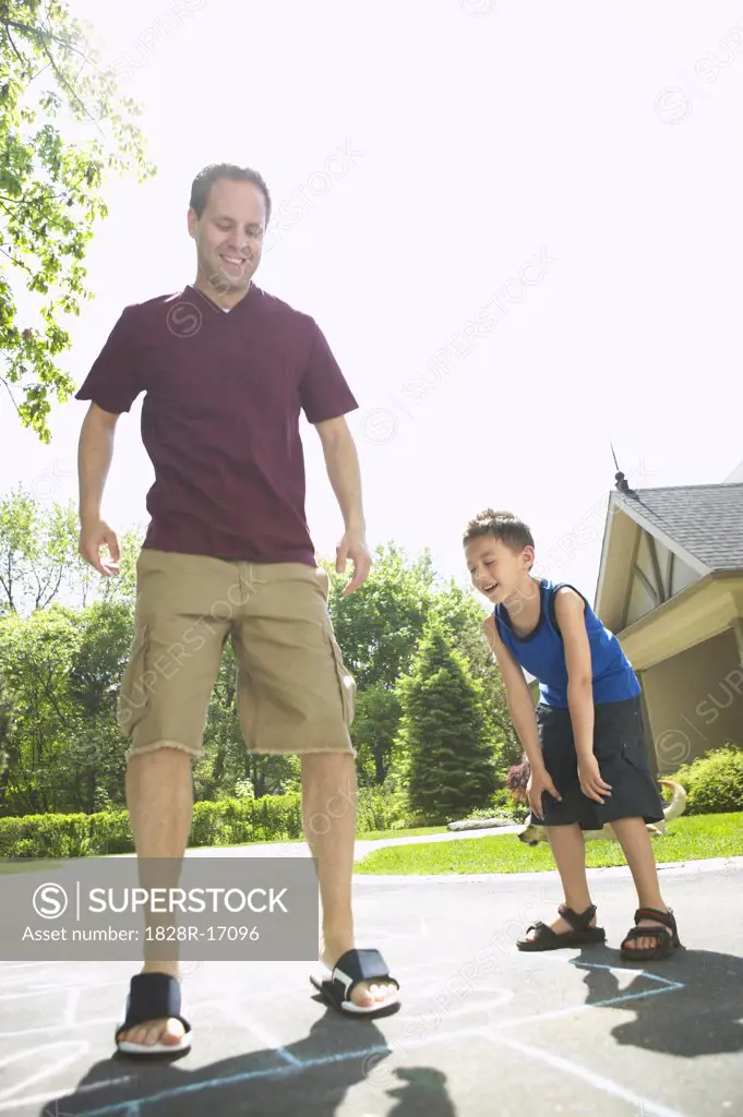 Father and Son Playing Hopscotch   