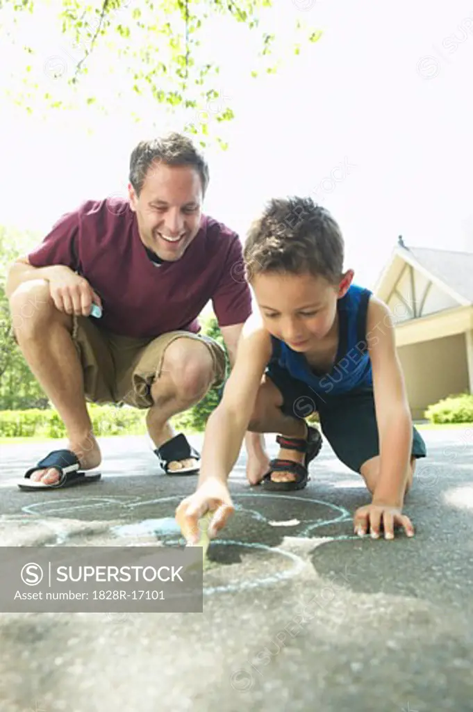 Father and Son Drawing with Chalk   