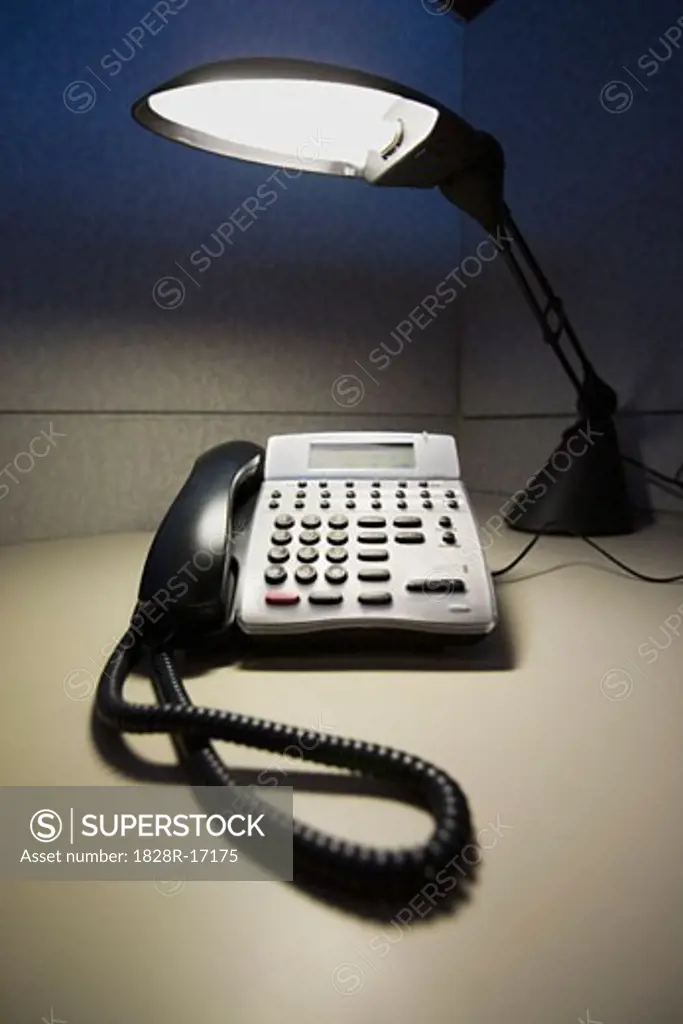 Telephone and Desk Lamp in Cubicle   