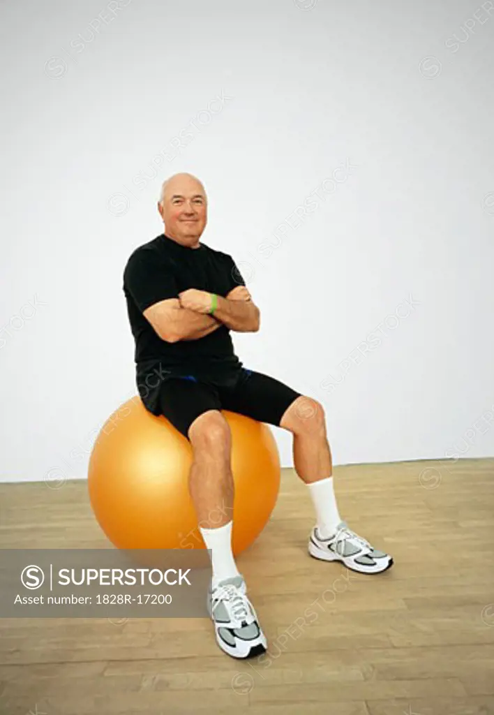 Portrait of Man Sitting on Exercise Ball   