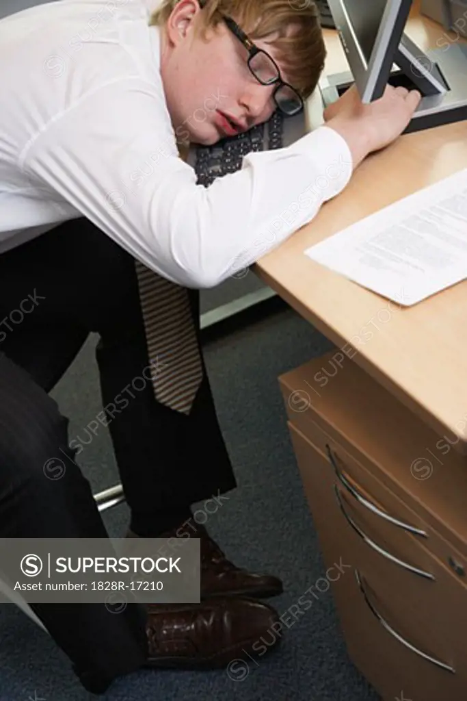 Businessman Asleep at Desk   