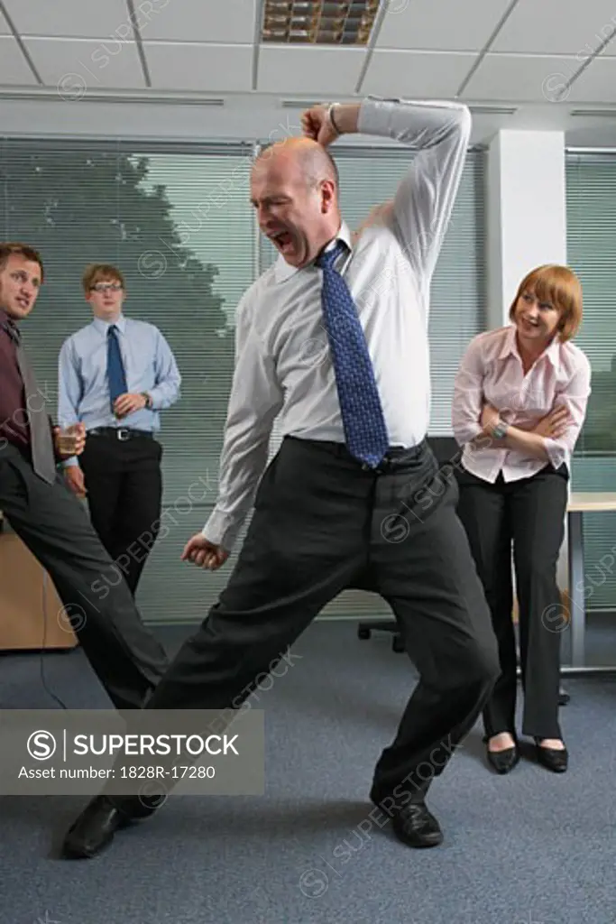 Manager Dancing for Staff in Office   