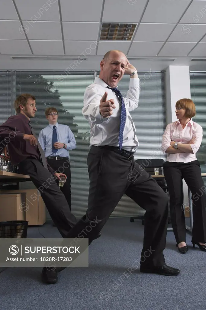 Manager Dancing for Staff in Office   