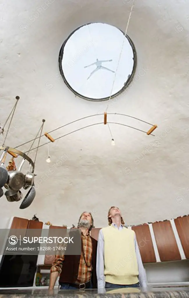 Father and Son Looking at Skylight in Kitchen   
