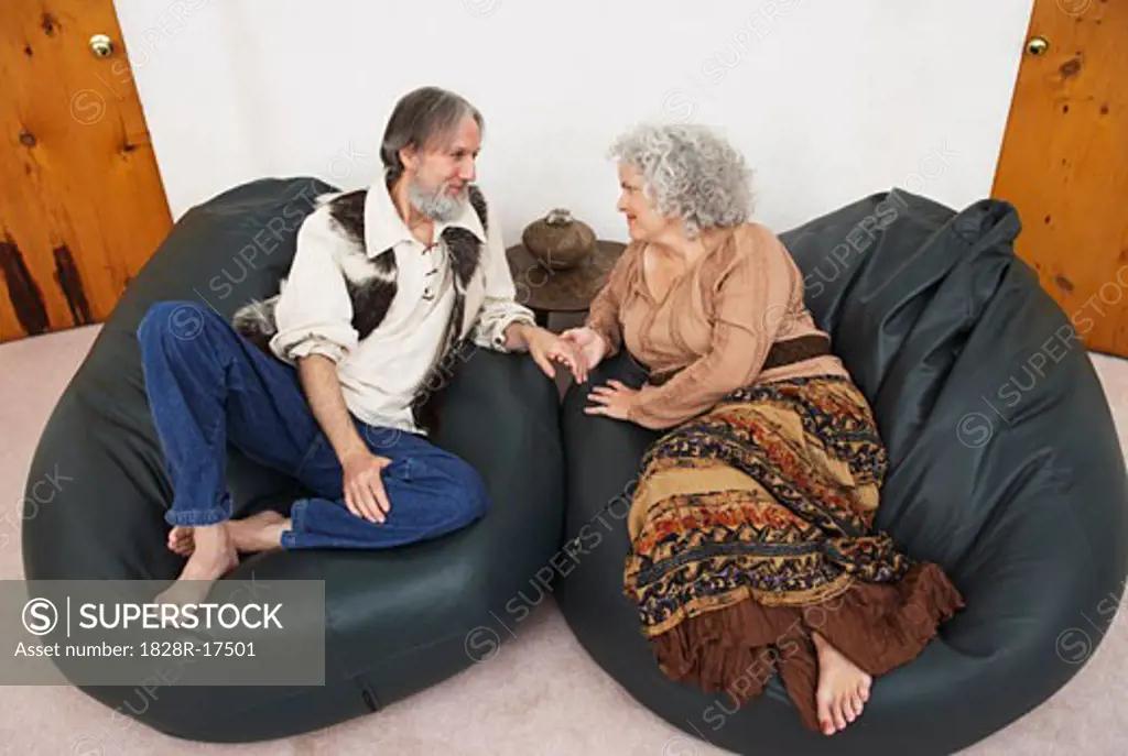 Couple Sitting in Bean Bag Chairs   