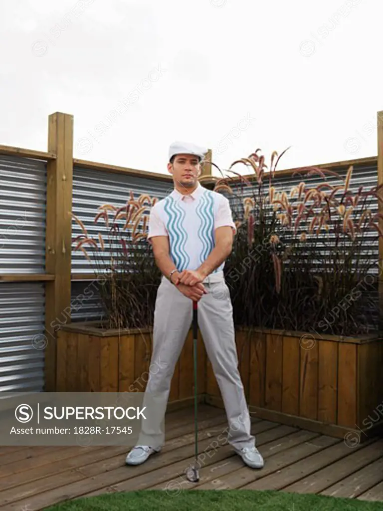 Portrait of Man Holding Golf Club   