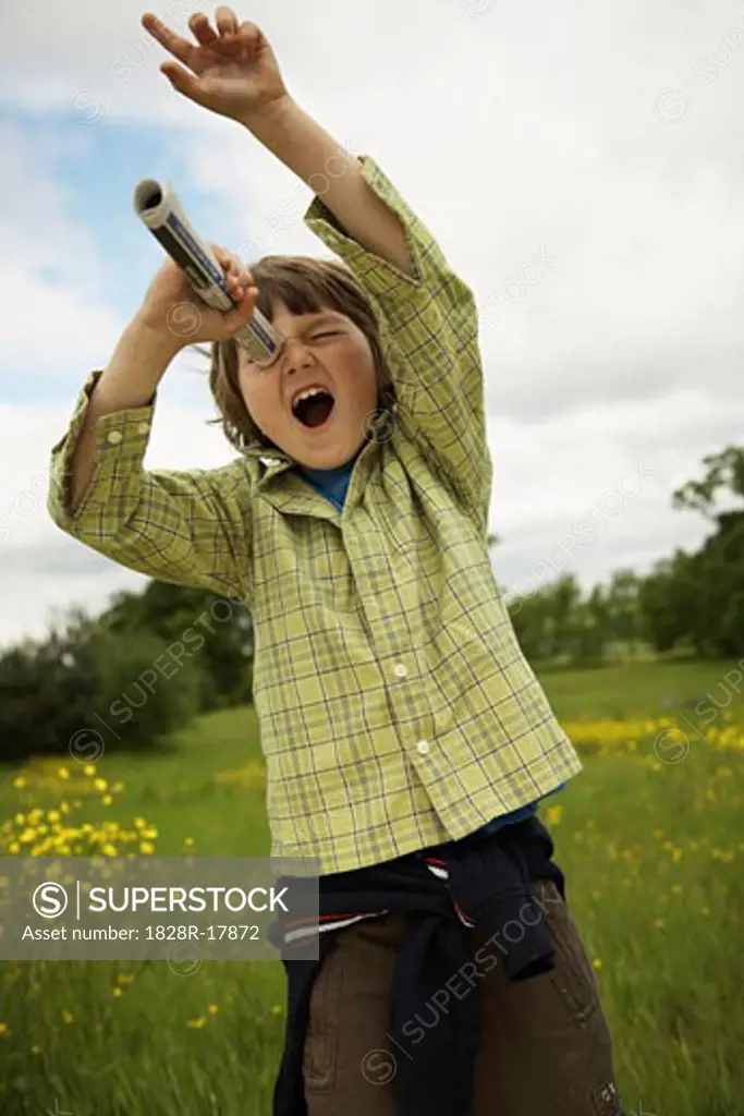 Boy Looking through Rolled Up Paper Tube   