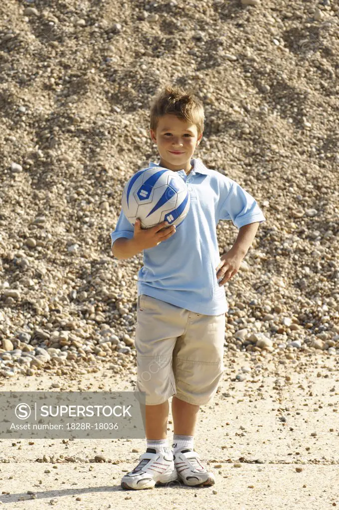 Boy Holding Soccer Ball   