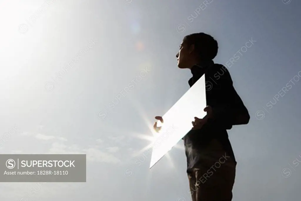 Woman Reflecting Sun in Mirror   