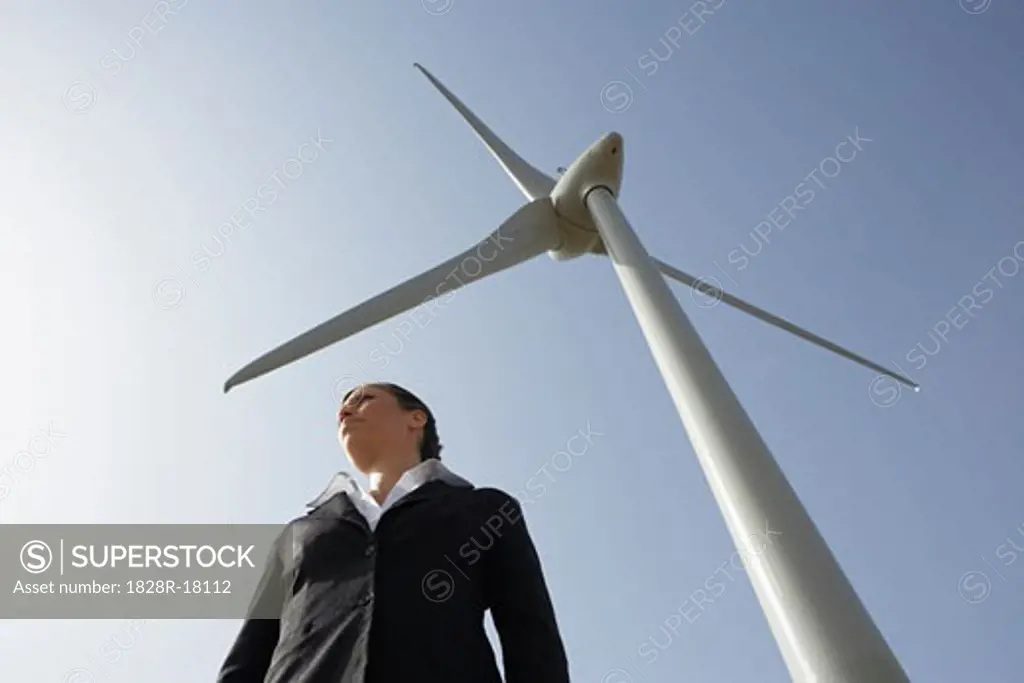 Business Woman beside Wind Turbine   