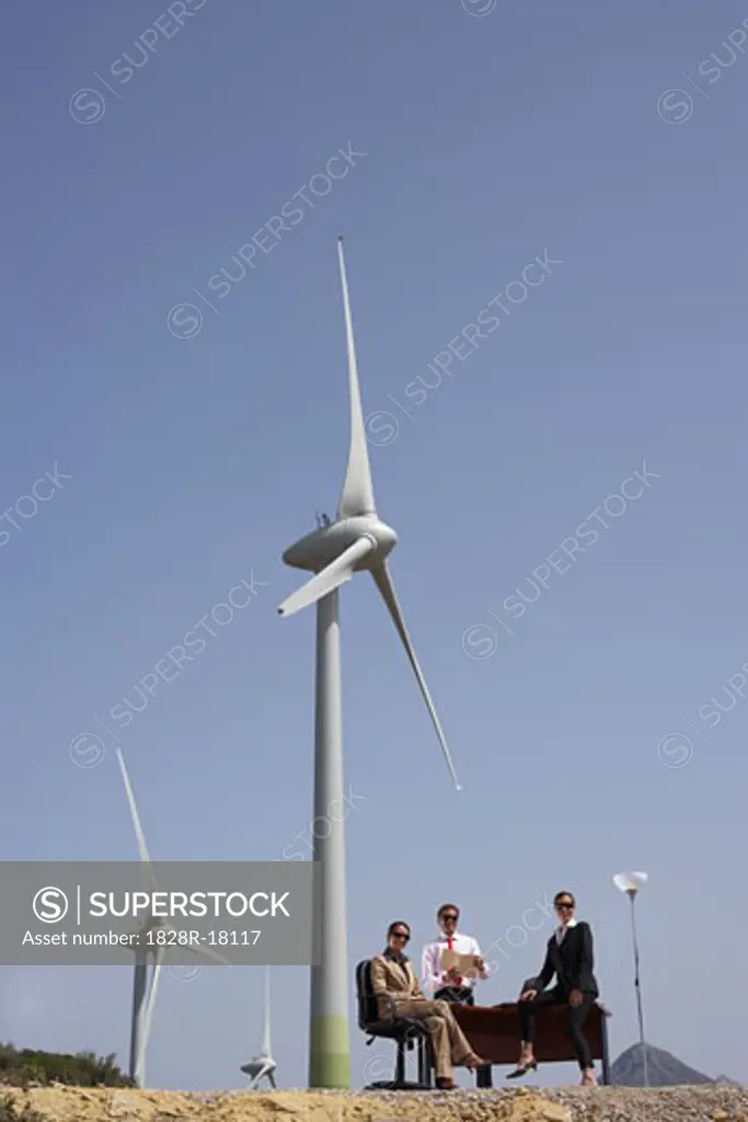 Business People at Desk by Wind Farm   