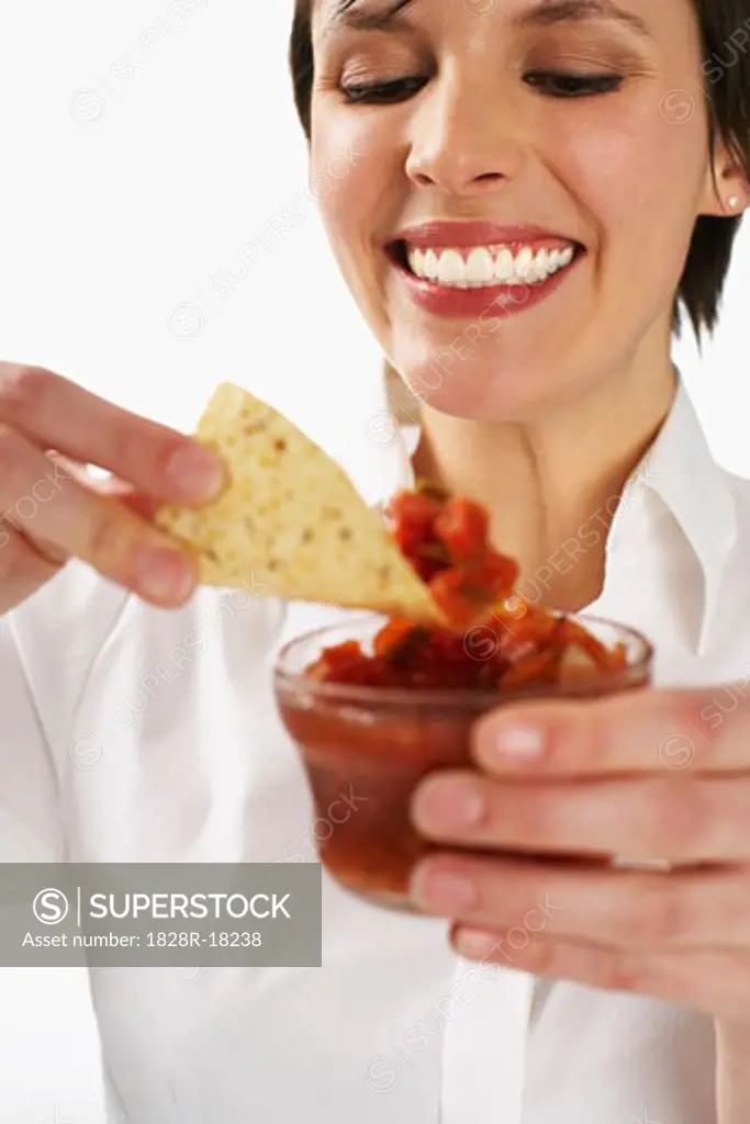 Woman Eating Salsa and Nachos   