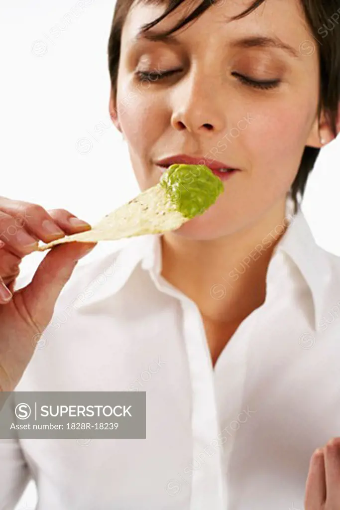Woman Eating Gucamole and Nachos   