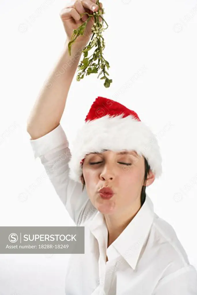 Woman Wearing Santa Hat and Holding Mistletoe   