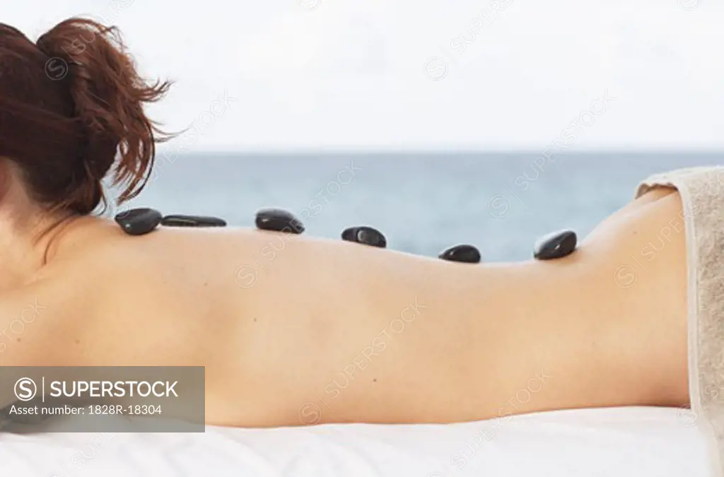 Woman Getting Warming Rock Therapy   