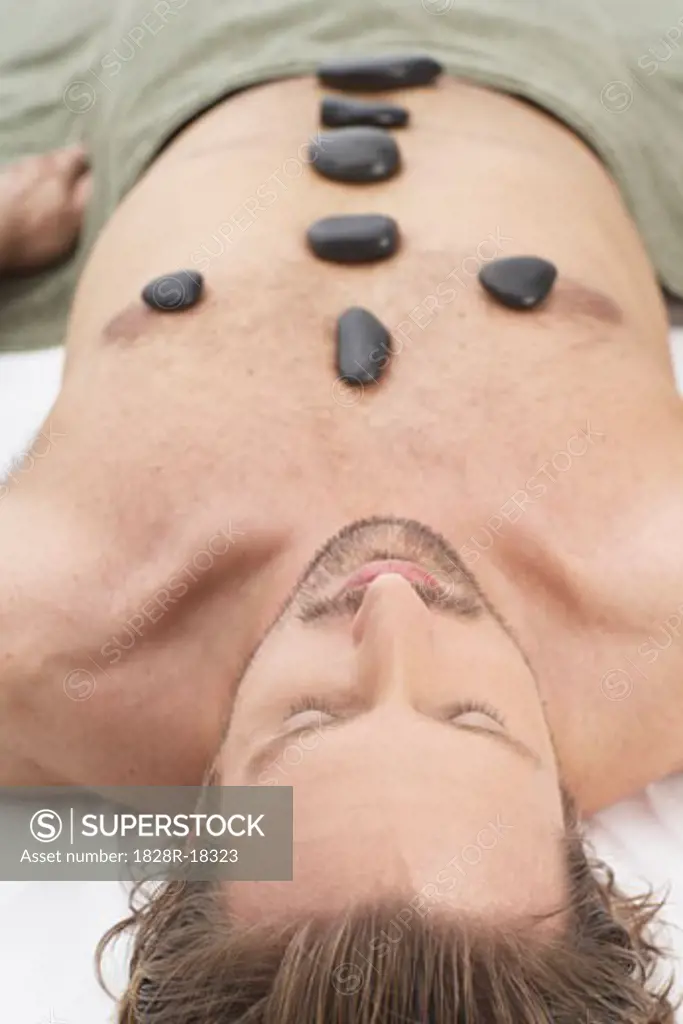 Man Getting Warming Rock Therapy   