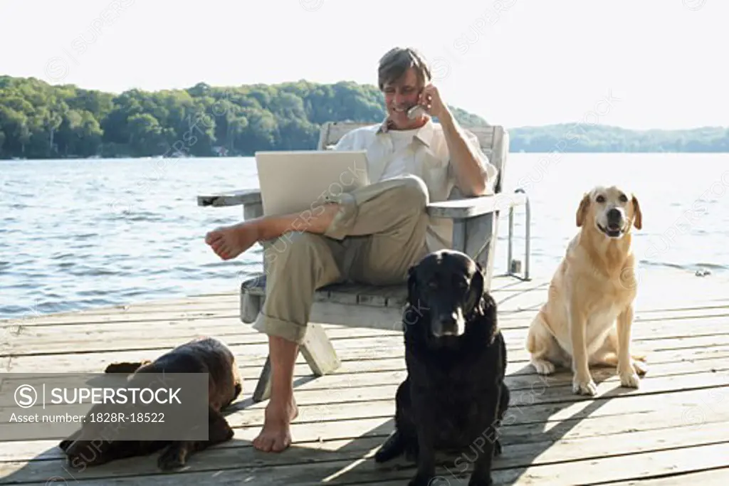 Man on Dock with Dogs, Three Mile Lake, Muskoka, Ontario, Canada   