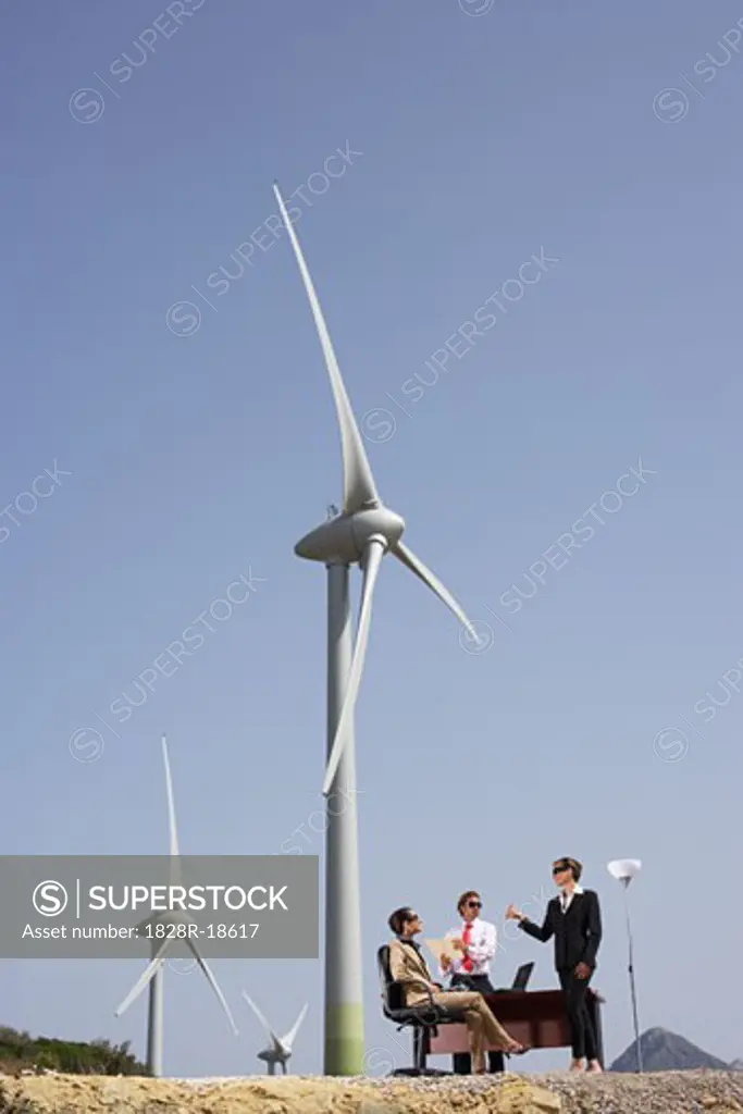 Business People around Desk at Wind Farm   